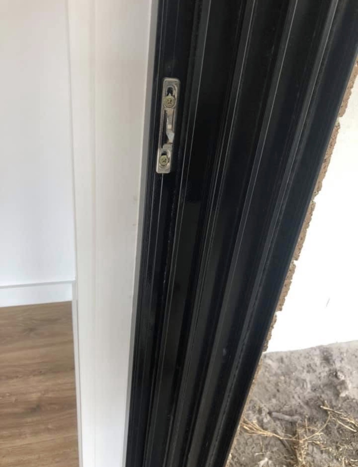 The same sliding door frame after repair, the aluminium line running straight with no kink.